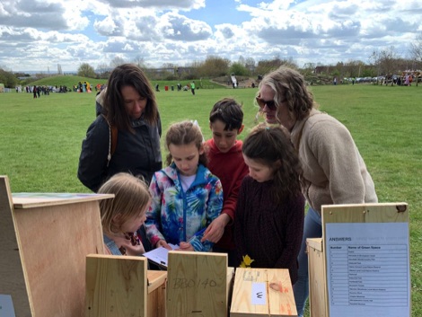 Women and children looking at bird boxes